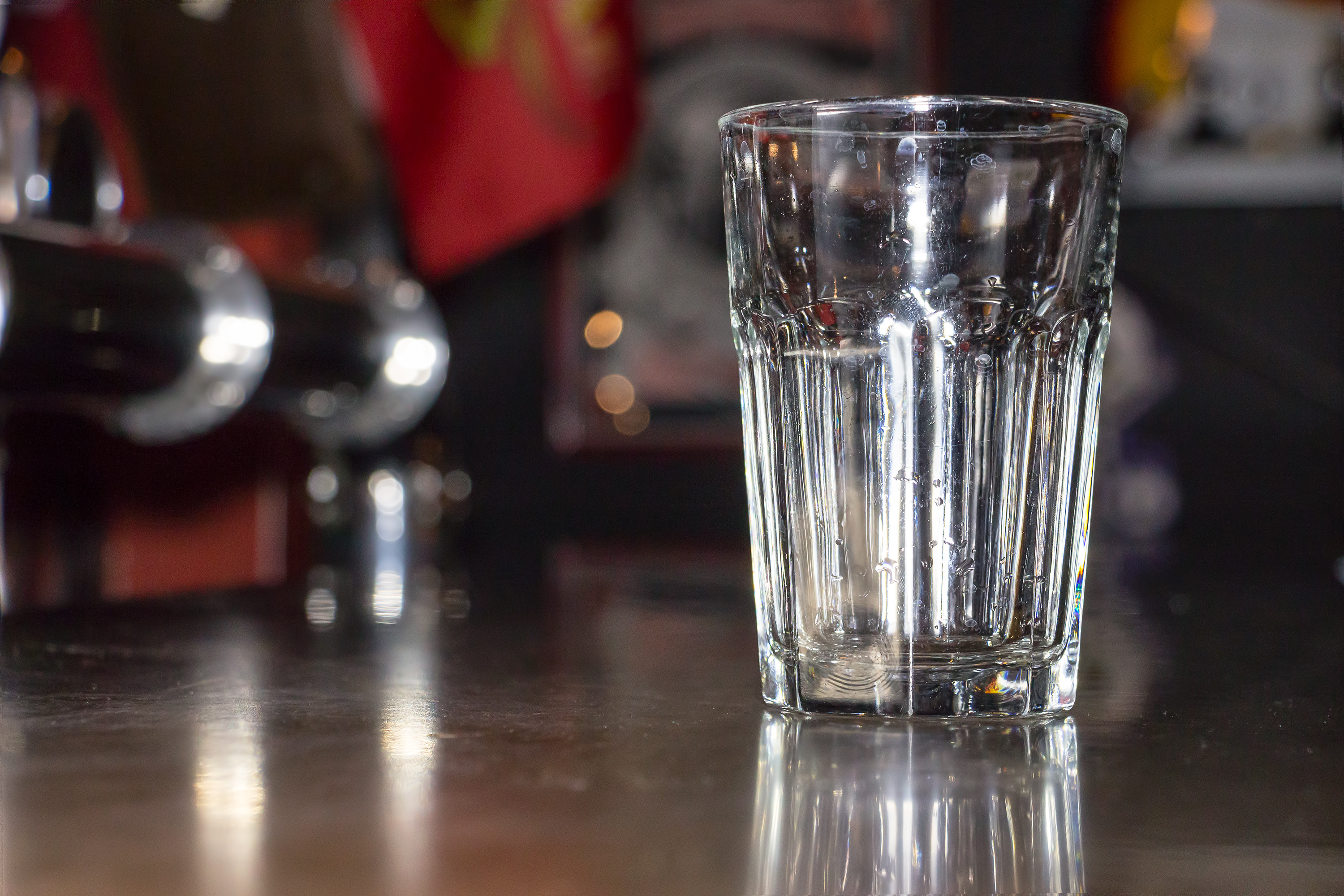 Empty glass stands on the bar 2